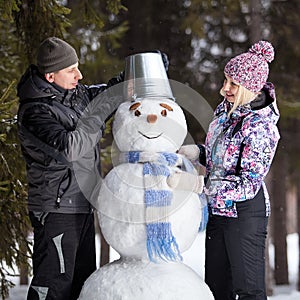 Couple makes snowman