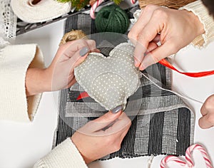 Couple making decorations for Valentine`s day, recover damaged heart, top view - romantic and love concept