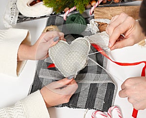 Couple making decorations for Valentine`s day, recover damaged heart, top view - romantic and love concept