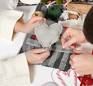 Couple making decorations for Valentine`s day, recover damaged heart, top view - romantic and love concept