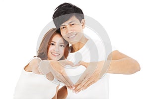 Couple making heart shape by hands