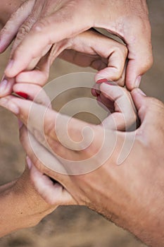 Couple making heart shape of hands