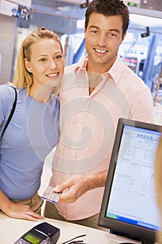 Couple making purchase with credit card