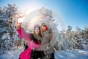 Couple making selfie and having fun on the snow