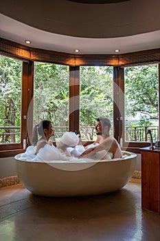 couple man and woman in bathtub, South Africa Kwazulu natal, luxury safari lodge in the bush