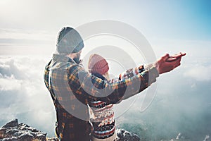 Couple Man and Woman holding hands raised on mountain summit