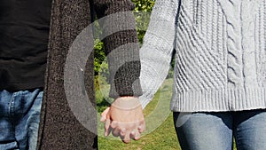 The couple of man and woman is holding hands together on green background