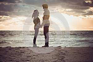 Couple Man and Woman in Love standing on Beach seaside