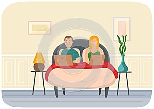 Couple man and woman lying on bed, holding laptops. Relaxing at home with social media network