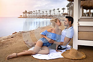 Couple man and woman on the ocean seashore - romantic hugs