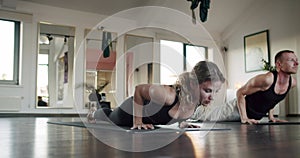 Couple man and woman practicing yoga on exercise mats in studio