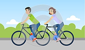 Couple of man and woman are riding a tandem bicycle outdoors.