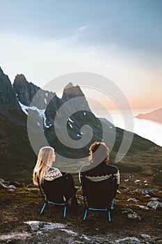 Couple man and woman travel together enjoying mountain view in Norway outdoor healthy lifestyle friends hiking