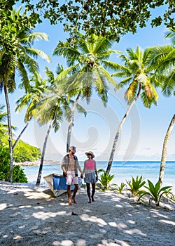 couple man and woman on vacation Seychelles, Mahe Seychelles, tropical beach with palm trees
