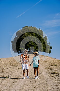 couple man and woman on vacation in Toscane Italy, man and woman mid age visiting Toscany region on the golden hills