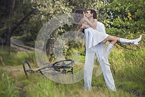 Couple man and woman in wedding style with bikes