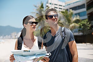 Couple, map and search with journey on vacation, street and excited for giving direction. Woman, man and chart for