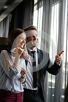 Couple or marriage in his new home looking through the window