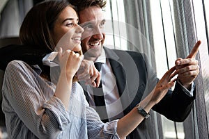 Couple or marriage in his new home looking through the window