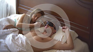 Couple in masks for sleep upset, lying in bed, problem. photo