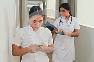 Couple Of Medics Looking At A Mobile Phone Screen