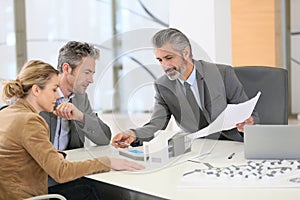 Couple meeting architect for construction project