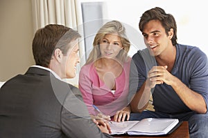 Couple Meeting With Financial Advisor At Home