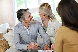 Couple meeting financial advisor at home