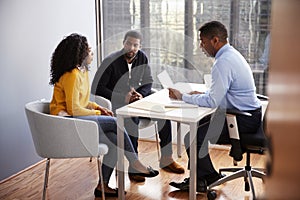 Couple Meeting With Male Financial Advisor Relationship Counsellor In Office