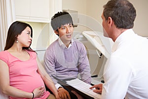 Couple Meeting With Obstetrician In Clinic photo