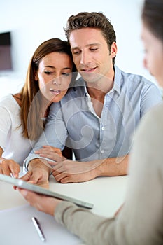 Couple meeting real estate agent