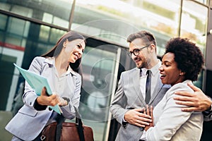 Couple meeting real-estate agent outside new property