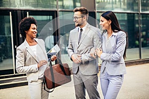 Couple meeting real-estate agent outside new property