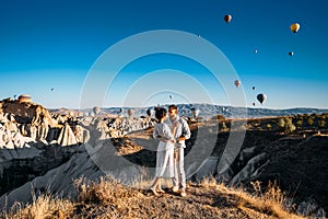 The couple meets the dawn. The man proposed to the girl. Family trip to Turkey. Couple at the balloon festival. Honeymoon trip.