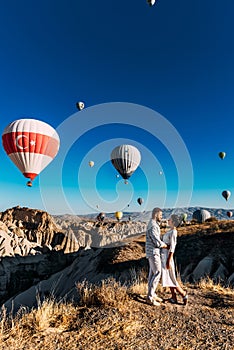 The couple meets the dawn. The man proposed to the girl. Family trip to Turkey. Couple at the balloon festival. photo