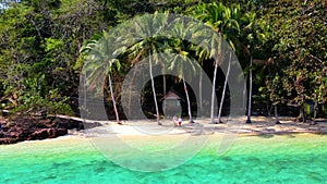 A couple of men and woman on the beach of Koh Wai Island Trat Thailand near Koh Chang