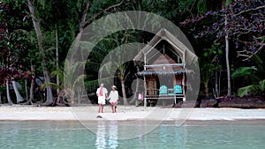 A couple of men and woman on the beach of Koh Wai Island Trat Thailand near Koh Chang