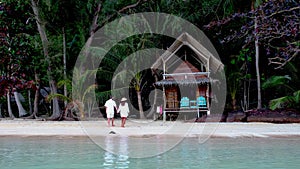 A couple of men and woman on the beach of Koh Wai Island Trat Thailand near Koh Chang