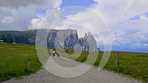 couple men and woman on Mountain bike at vacation in the Dolomites Italy, Alpe di Siusi Seiser Alm
