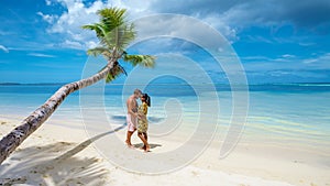 a couple of men and woman on vacation at the beach of the Seychelles,