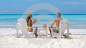 couple men and women on the beach with coconut drink, Praslin Seychelles tropical island