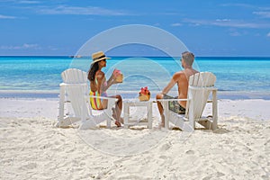 couple men and women on the beach with coconut drink, Praslin Seychelles tropical island