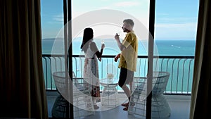 Couple of men and women drinking cocktails on the balcony of an hotel in Pattaya Thailand