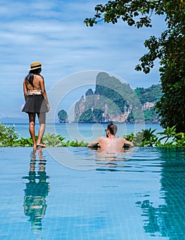 couple men and women at infinity pool looking out over the beach of Koh Phi Phi Thailand