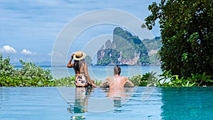 couple men and women at infinity pool looking out over the beach of Koh Phi Phi Thailand