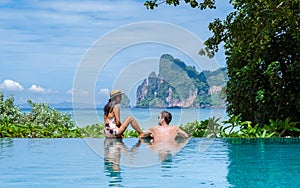 couple men and women at infinity pool looking out over the beach of Koh Phi Phi Thailand