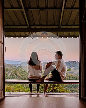 A couple of men and women watching sunrise ,Morning mist Viewpoint Phu Pha Mok Baan Jabo