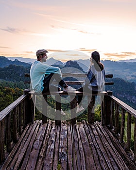 A couple of men and women watching sunrise ,Morning mist Viewpoint Phu Pha Mok Baan Jabo