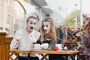 A couple of merry mimes. He hurries on a date