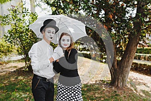 A couple of merry mimes. He hurries on a date